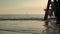 Beautiful seascape of a sailboat approaching a pier at sunset