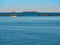 A beautiful seascape of a sailboat floating behind a brake water during the golden hour