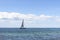 Beautiful seascape. Sailboat floats on the blue sea.