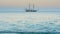 Beautiful seascape with sailboat on horizon and sea waves beating on shore