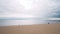 Beautiful seascape with sandy beach on background cloudy sky. Action. Cloudy sky hung over quiet sea with sandy beach