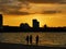 Beautiful seascape scenery with three girls during sunset at Tanjung Lipat beach,Sabah.