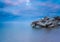 Beautiful seascape with stony breakwater. Long exposure photo.