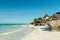 Beautiful seascape with thatched houses on Zanzibar beach