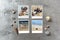 Beautiful seaside snapshots arranged on rustic wooden background with seashells around