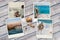 Beautiful seaside snapshots arranged on rustic wooden background with seashells around