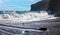 Beautiful secluded black lava sand beach bay, rocks, big strong splashing waves, blue sky - Caleta playa Hermigua, La Gomera