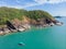 Beautiful secret beach Butterfly in Goa, India. Aerial view of pristine beach with rocky bay and waves crashing.