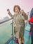 Beautiful Senior asian women stand on Tianmen mountain Glass balcony with winning Pose and beautfiul View on the mountain at zhang