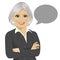 Beautiful senior businesswoman with arms crossed standing next to gray blank speech bubble