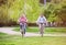 Beautiful senior couple with bicycles outside in spring nature, cycling.