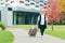 Beautiful senior woman travels with a large travel suitcase, on the background of a beautiful modern building	 Category	 People