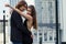 Beautiful sensual elegant couple stands on a city street and embraces