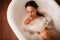 Beautiful sensual woman relaxing in spa bathtub