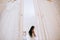 Beautiful sensual young bride with a white wedding dress and groom in bedroom. Last preparations for the wedding. Wedding morning