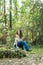 A beautiful serious teen brunette girl looking away from the camera towards the future in a wooded area in the spring