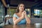 Beautiful serious woman sitting in summer cafe