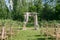 Beautiful setting for outdoors wedding ceremony waiting for bride and groom and guests. Wooden chairs decorated with