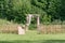 Beautiful setting for outdoors wedding ceremony waiting for bride and groom and guests. Wooden chairs decorated with