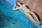 Beautiful sexual woman lying near pool on resort