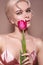 Beautiful sexy Blonde Woman with luxury Make-up. Girl with Spring Flowers Bouquet. Style for Womans Day or Valentines