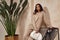 Beautiful sexy brunette woman face cosmetic makeup tanned skin wear fashion clothes style collection beige knitted suit sandals