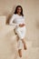 Beautiful sexy brunette woman tanned skin face cosmetic makeup wear white suit pants for date walk office fashion clothes style