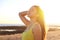 Beautiful sexy woman enjoying breeze on the beach at sunset