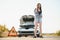 Beautiful sexy woman near a broken car. Confused woman does not know what to do