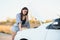 Beautiful sexy woman near a broken car. Confused woman does not know what to do