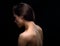 Beautiful sexy woman with nude healthy back and health skin, spine, neck isolated on black background with empty copy space.