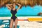 Beautiful sexy woman, surfer in bikini posing on the Caribbean beach