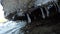 Beautiful shapes on clean icicles hanging from concrete barrier