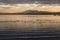 Beautiful and sharp water ripples on Trasimeno lake Umbria, Italy at sunset, with ducks and distant hills