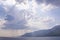 Beautiful shiny clouds above Aegean Islands on sea and mountains background, Turkey