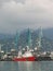 Beautiful ship on a background of blue lifting cranes