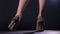 Beautiful shoes with high heels on women standing, then changing her position, turning around, close-up showing her legs