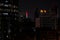 Beautiful shot of Abu Dhabi towers at night with the UAE flag displayed on a screen