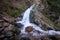 Beautiful shot of All Saints Waterfall flowing on rocks