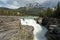 Beautiful shot of the Athabasca Falls surrounded by green trees in Alberta Canada