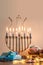 Beautiful shot of a burning Menorah lampstand next to pastry in celebration of Hanukkah