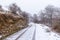 Beautiful shot of car tracks and shoe steps on the snowy road of Gipuzkoa\\\'s mount Aizkorri