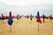 Beautiful shot of closed umbrellas on a beach shore with a cloudy sky in the background
