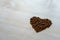 Beautiful shot of the coffee mug in the morning on the white wooden table with coffee heart shaped beans. Perfect for copy valent