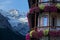 Beautiful shot of colorful flowers covering balcony of a hotel in the mountains