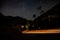 Beautiful shot of dark starry night sky over a road and the Big Cottonwood Canyon