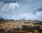 Beautiful shot of empty grassy hills under a blue cloudy sky