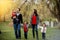 Beautiful shot of a family with parents and three kids in the park