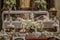 Beautiful shot of flowers, candles, and chalice in the white altar of a church