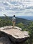 Beautiful shot of a German standing on top of the Dragon Rock in Palatinate Forest